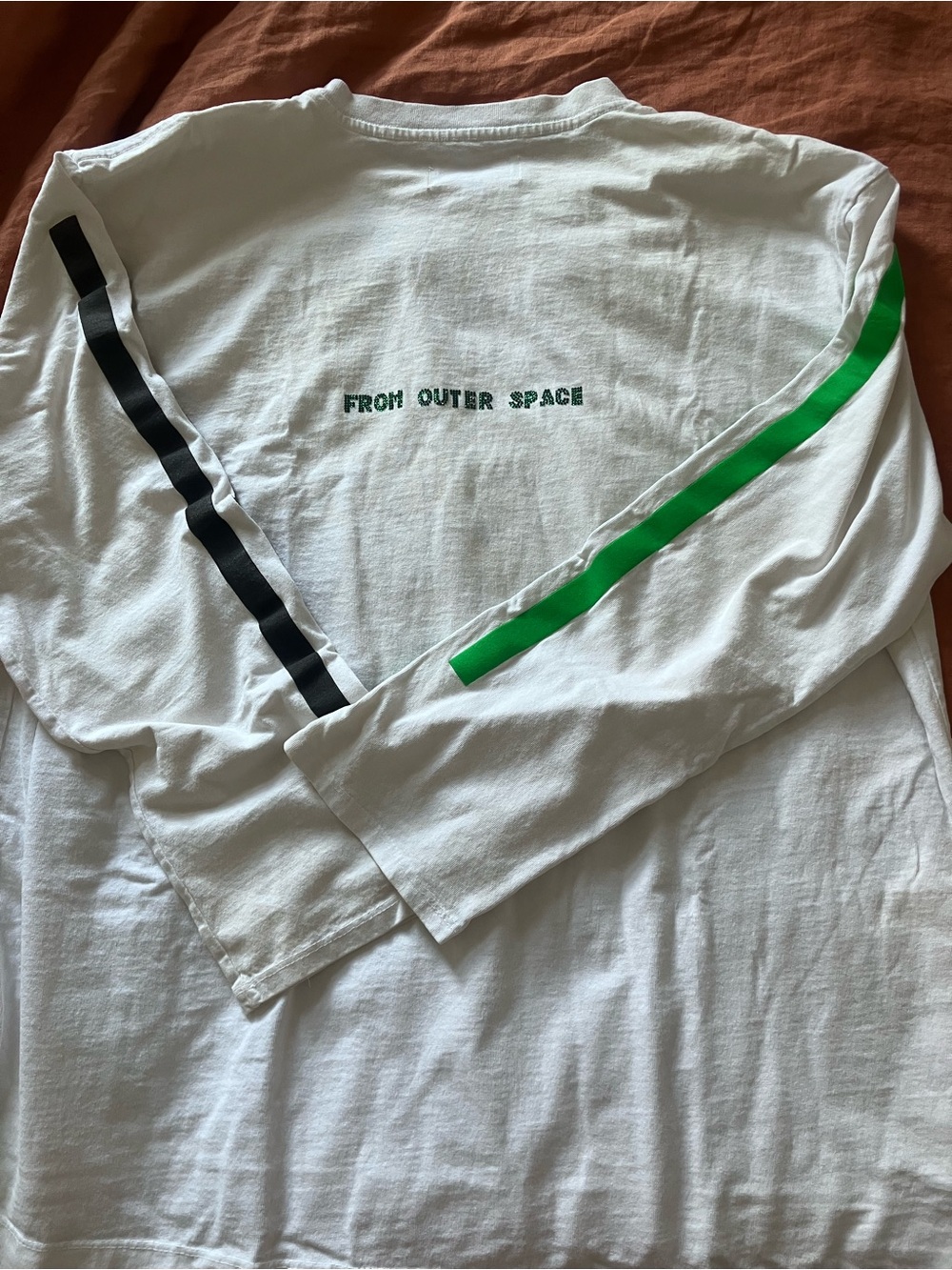 White Long Sleeve Tee with Green Chest Text and Sleeve Stripes